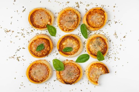 Nine small Margherita pizzas