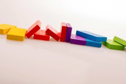 Colorful Domino Blocks in a line on a white background