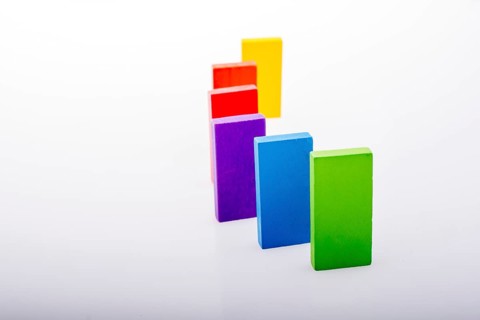 Colorful Domino Blocks in a line on a white background