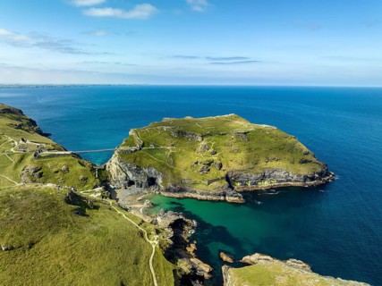 Aerial view of the rugged coastline on the Celtic Sea with the Tintagel Peninsula and the ruins of Tintagel Castle