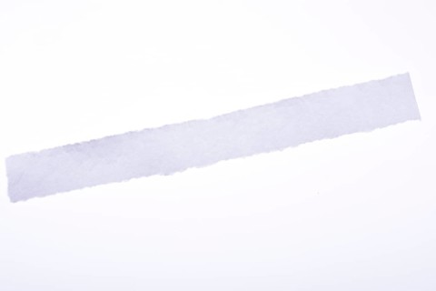 A piece of white blank torn note paper