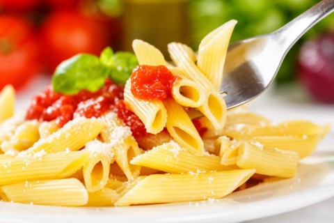 Penne Rigatoni Rigate Italian pasta with fork in tomato sauce eat lunch dish on plate in Stuttgart