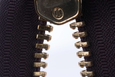 Close up or macro of a brown zipper on white background
