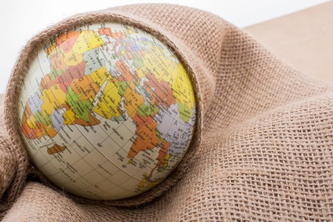 Linen canvas is wrapped around a model globe