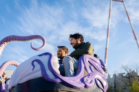 Couple of latin friends having fun in an amusement park