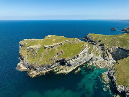 Aerial view of the rugged coastline on the Celtic Sea with the Tintagel Peninsula and the ruins of Tintagel Castle