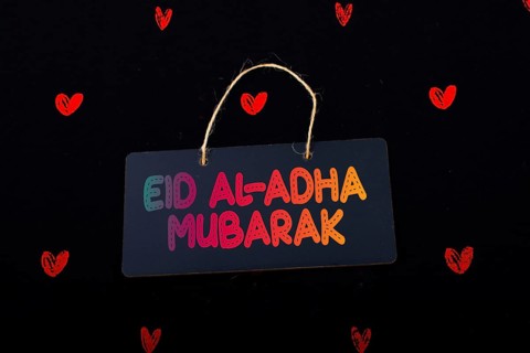 Rectangular shaped black notice board and red hearts on black background