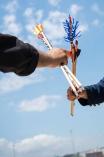 Hand holding old style wooden arrows