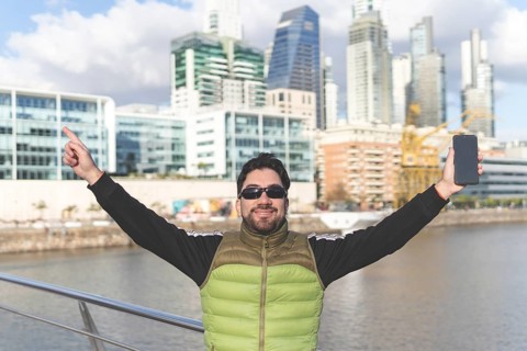 Happy tourist posing in Puerto Madero