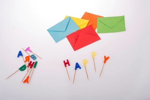 Colored envelopes and Color candles on sticks write happy