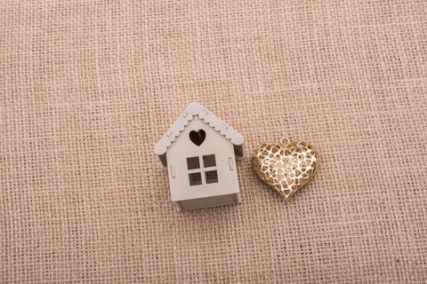 Heart shaped icon and model houses on a brown background