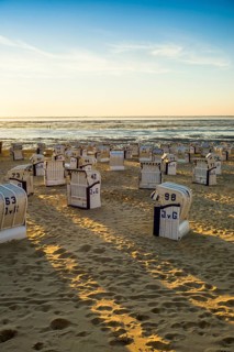 White beach chairs and mudflats