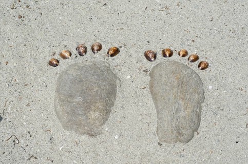 Footprints Made of Stones in the Sand
