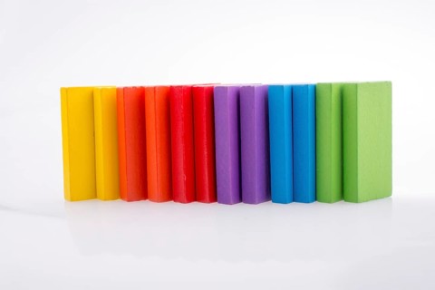 Colorful Domino Blocks in a line on a white background