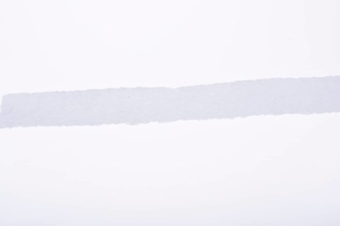 A piece of white blank torn note paper