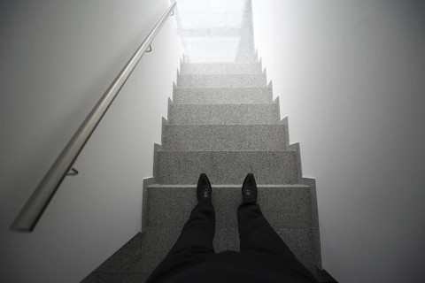 Man standing in the staircase with window light