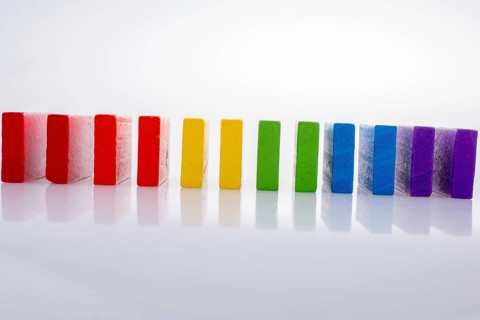 Colorful Domino Blocks in a line on a white background