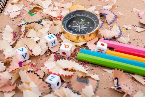 The compass instrument and a few colorful pencils