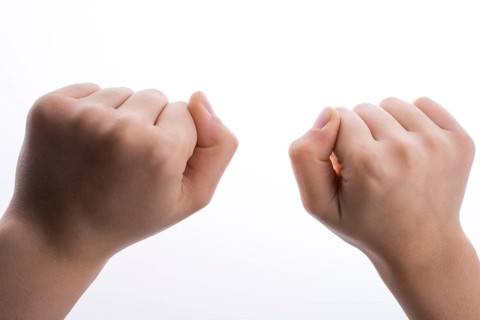 Clenched fists on a white background