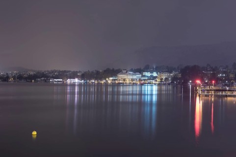Cityscape at Night with Lake Zurich and Mountain in Switzerland