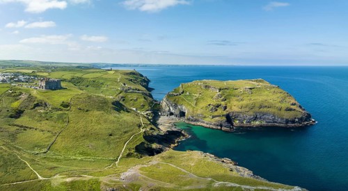 Aerial panorama of the rugged coastline on the Celtic Sea with the Tintagel Peninsula and the ruins of Tintagel Castle