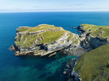 Aerial view of the rugged coastline on the Celtic Sea with the Tintagel Peninsula and the ruins of Tintagel Castle