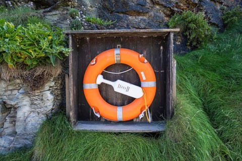 Lifebelt with lifebuoy on a rock face near Tintagel Castle