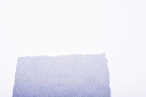 A piece of white blank torn note paper