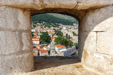 View of the old town through an opening in the wall of the fortress in Dubrovnik