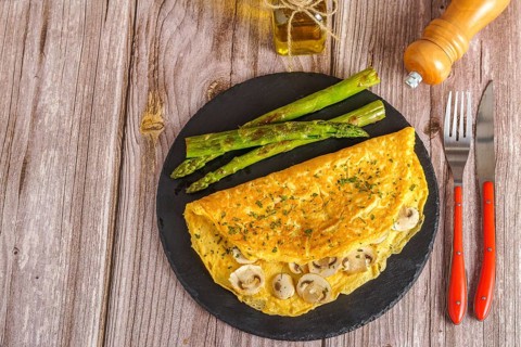 Mushroom omelette with wild asparagus on a slate