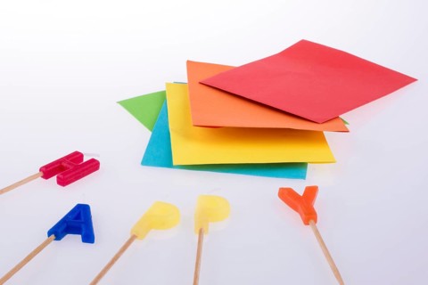 Colored envelopes and Color candles on sticks write happy