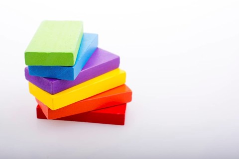 Colorful Domino Blocks in a line on a white background