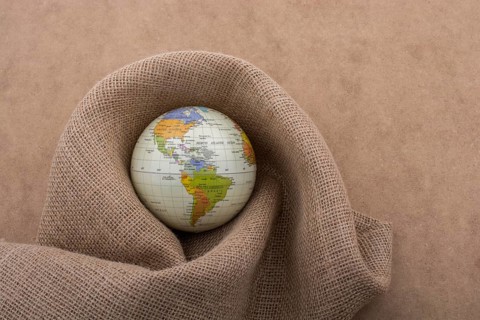 Linen canvas is wrapped around a model globe