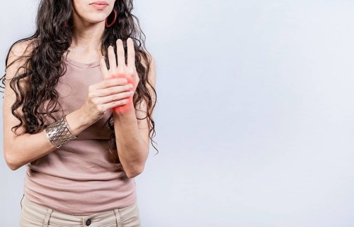 Girl suffering with joint pain of hands. People with arthritis and hand pain isolated. Woman suffering from arthritis in her hands