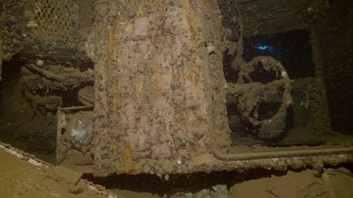 Close-up of truck cab lying on its side inside hold of ferry Salem Express shipwreck