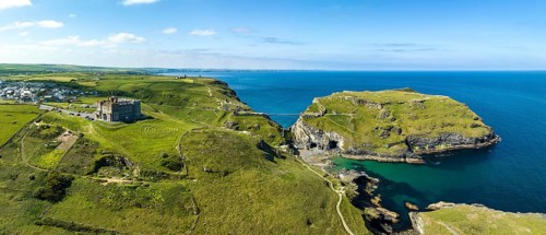 Aerial panorama of the rugged coastline on the Celtic Sea with the Tintagel Peninsula and the ruins of Tintagel Castle