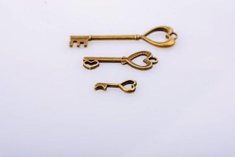 Heart shaped retro metal keys on white background