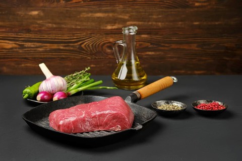 Uncooked beef steak boneless on cast iron skillet