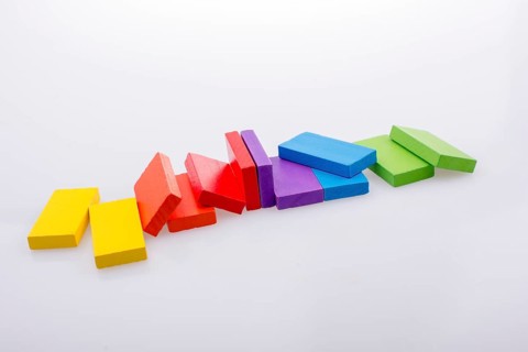 Colorful Domino Blocks in a line on a white background