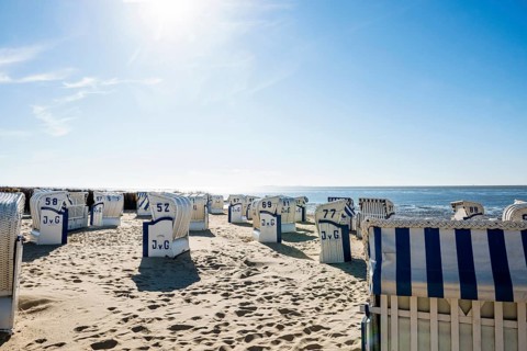 White beach chairs and mudflats