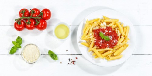 Penne Rigatoni Rigate Italian pasta in tomato sauce eat lunch dish on plate from above Panorama in Stuttgart