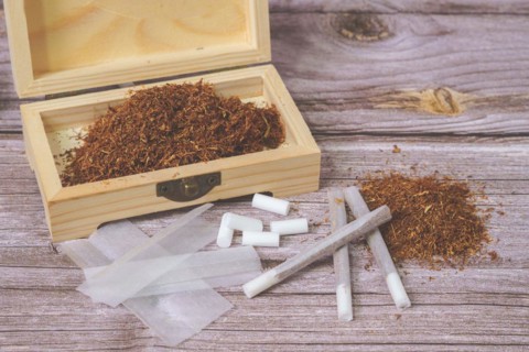 Wooden box with rolling tobacco