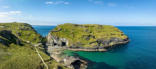 Aerial panorama of the rugged coastline on the Celtic Sea with the Tintagel Peninsula and the ruins of Tintagel Castle