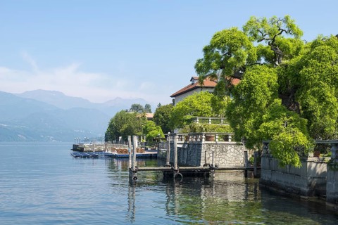 Port and Houe on Waterfront on Lake Orta in a Sunny Day with Mountain in Piedmont