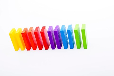 Colorful Domino Blocks in a line on a white background