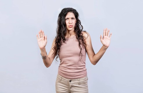 Scared woman with raised hands isolated. Young woman with scared face with raised hands