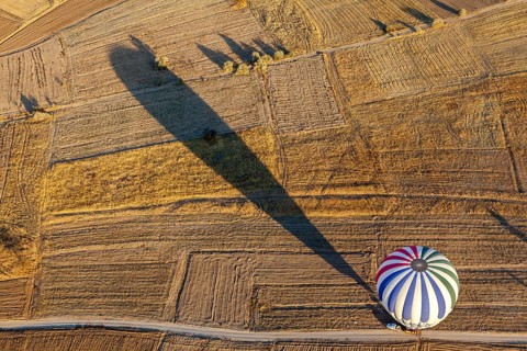 Hot air balloon over fields