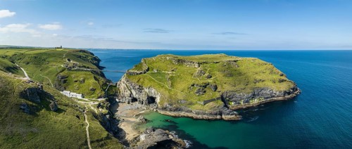 Aerial panorama of the rugged coastline on the Celtic Sea with the Tintagel Peninsula and the ruins of Tintagel Castle