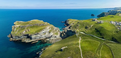 Aerial panorama of the rugged coastline on the Celtic Sea with the Tintagel Peninsula and the ruins of Tintagel Castle