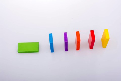 Colorful Domino Blocks in a line on a white background